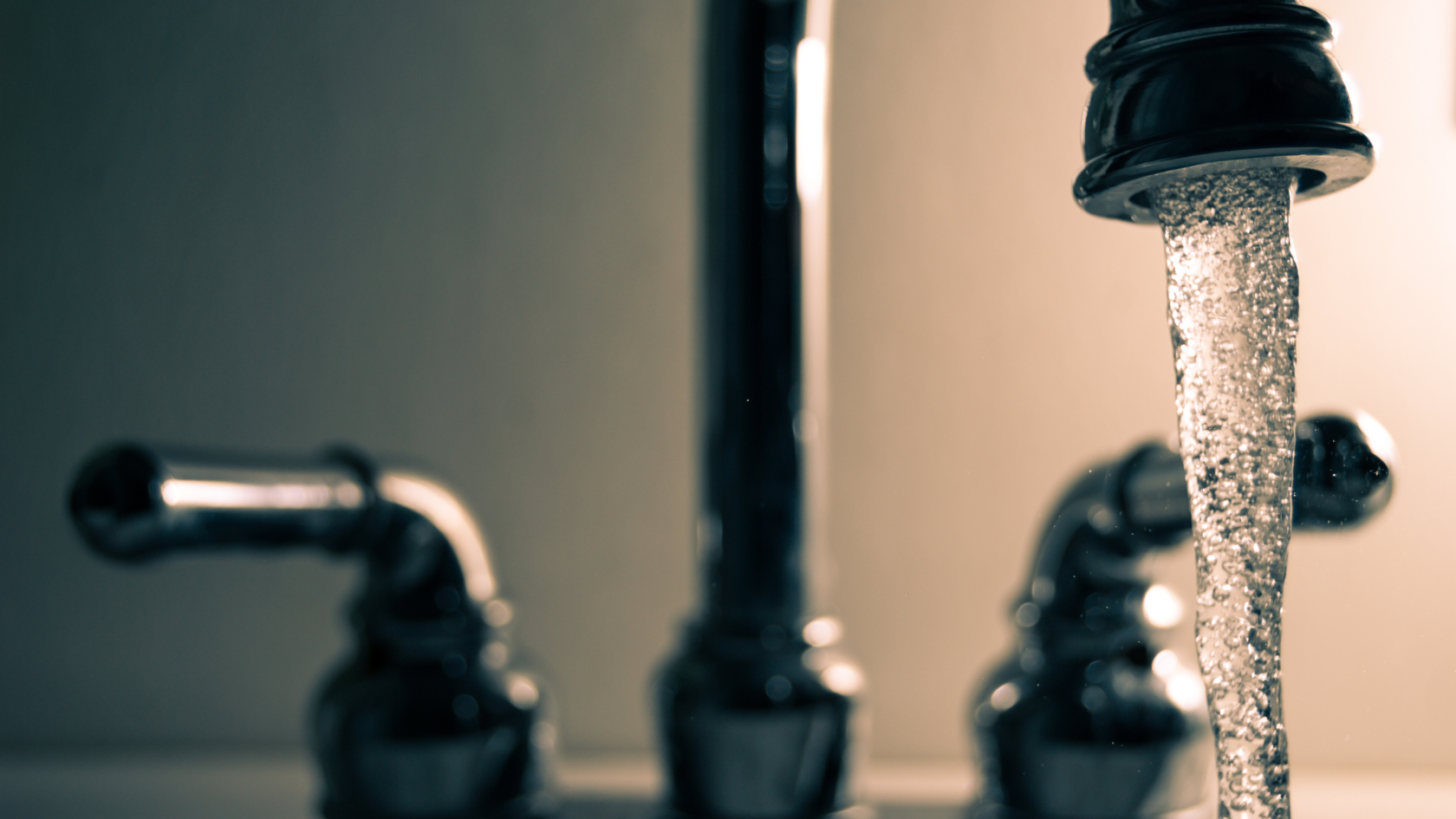 A faucet running water from a faucet in a bathroom